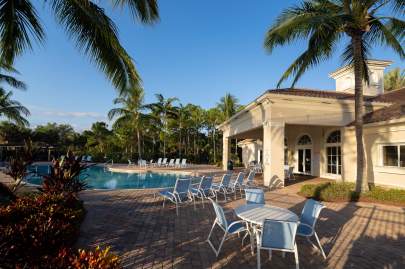 A different view of resort-style heated swimming pool with plenty of seating, and shaded pavilion adjacent to pool.